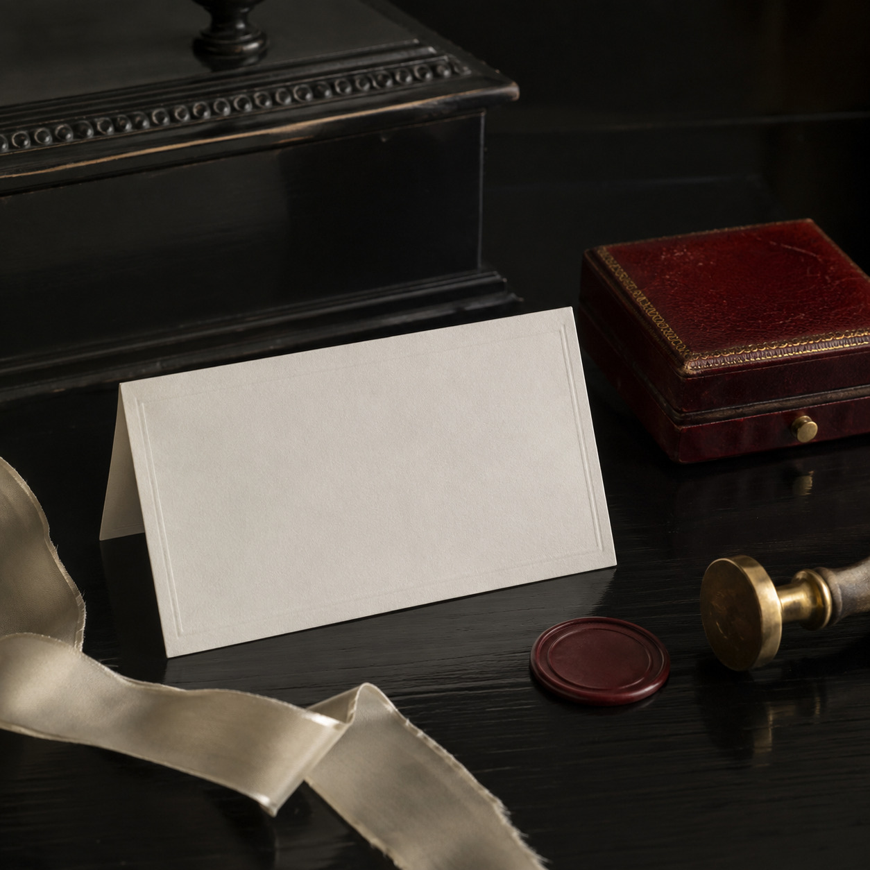 Blank trade card, oxblood presentation case, sealing wax, brass seal and silk ribbon.