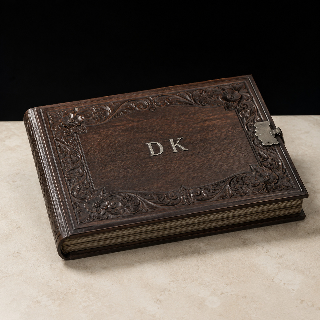 Editorial reconstruction of a carved wooden cabinet photograph album with D K initials and a silvered clasp.