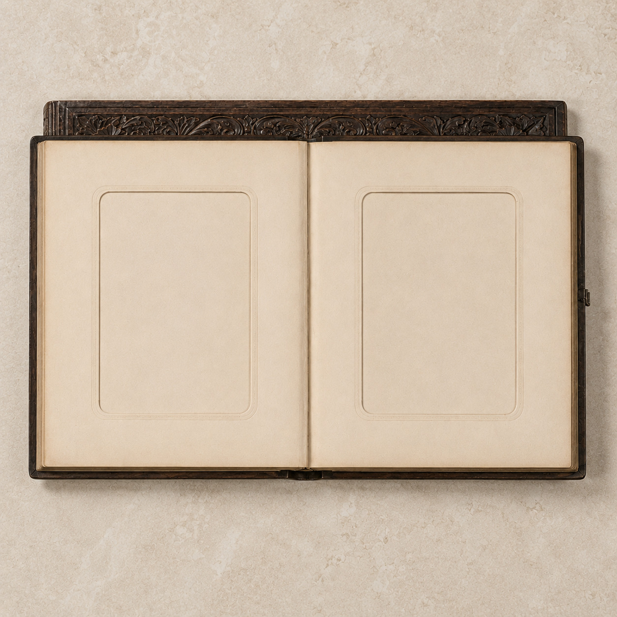 Editorial overhead view of an open album with two blank cream cabinet-card apertures.
