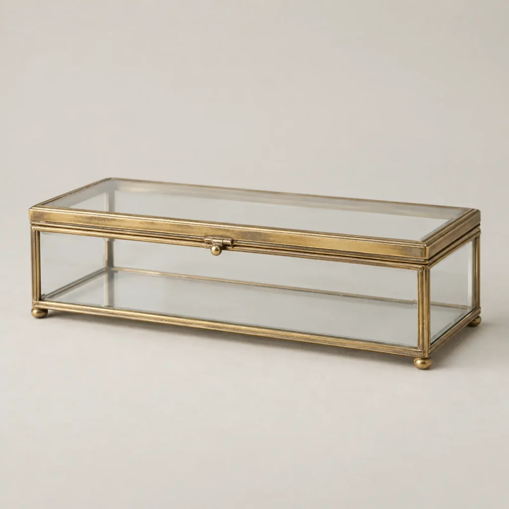 Editorial reconstruction of a rectangular glass box with silver-gilt mounts, three-quarter view.