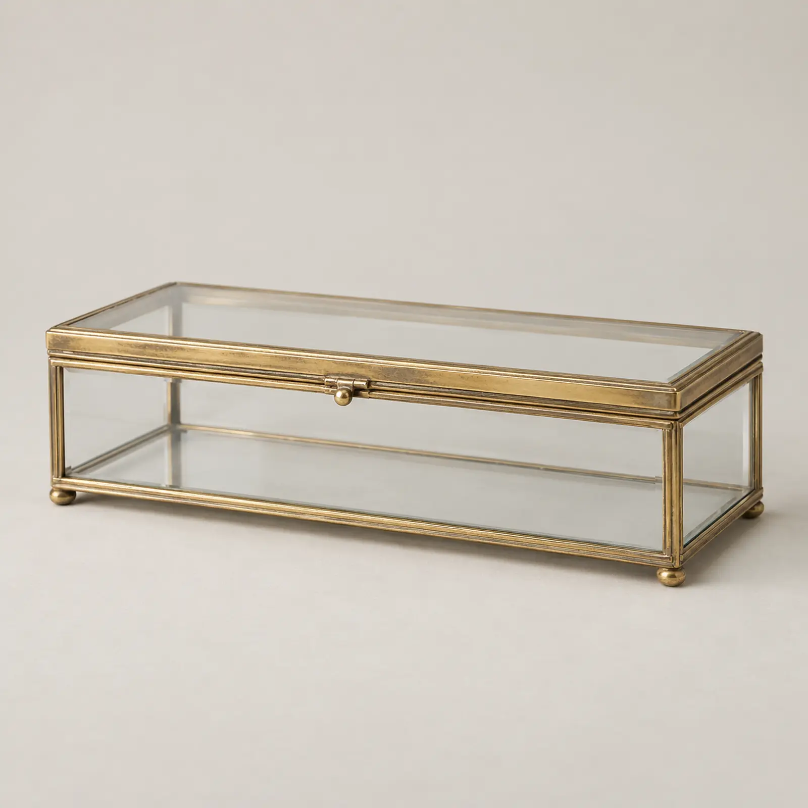Editorial reconstruction of a rectangular glass box with silver-gilt mounts, three-quarter view.