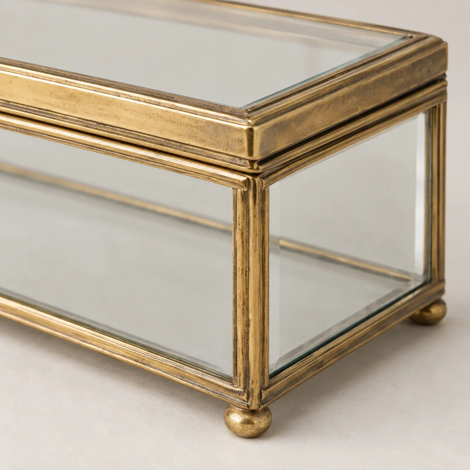 Close editorial reconstruction of clear glass meeting a silver-gilt mount.